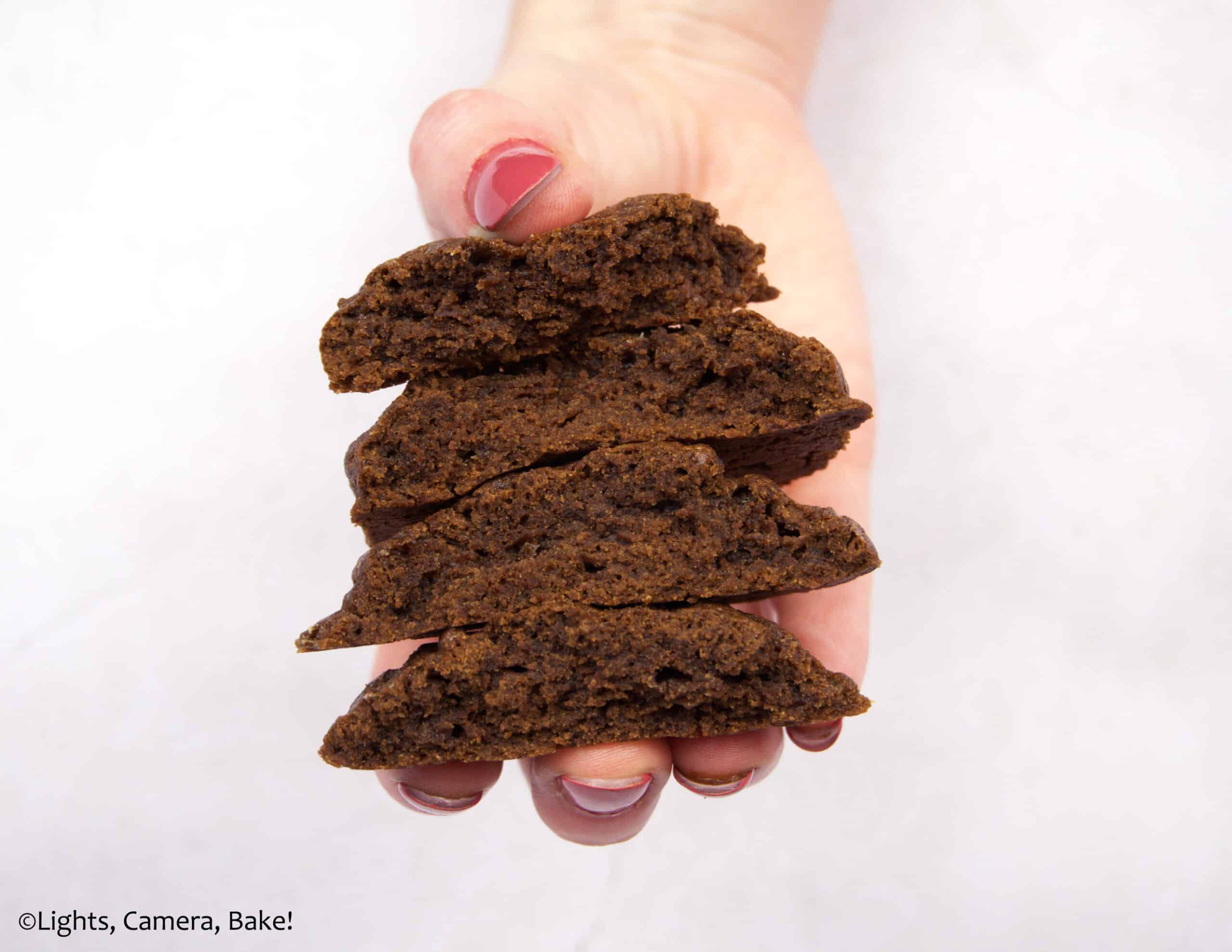 mocha cookies in a hand on a purple background