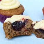 Raspberry Banana Cake Cupcakes with Cream Cheese Icing chopped in half with the raspberry jam filling