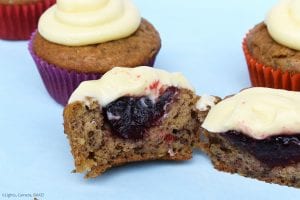 Raspberry Banana Cake Cupcakes with Cream Cheese Icing chopped in half with the raspberry jam filling