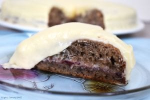 Raspberry Banana Cake with Cream Cheese Icing. Slice of banana cake with a raspberry jam filling.