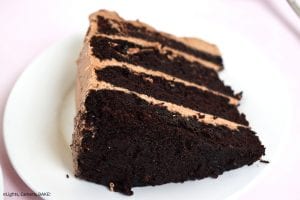 Nutella Chocolate Cake is a dense and fluffy chocolate mud cake with a creamy Nutella Buttercream filling and topping and finished with Nutella drizzled overtop. #nutellacake #nutellachocolatecake #chocolatecake #bestchocolatecake #nutellalayercake