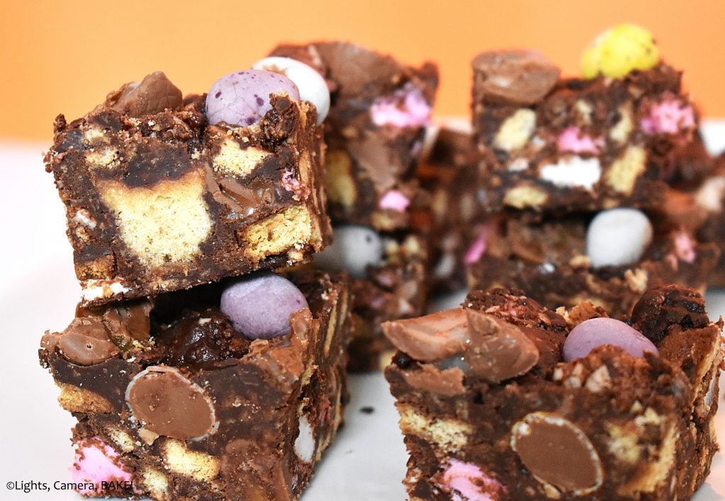 Slices of rocky road in a pile with an orange backgorund.