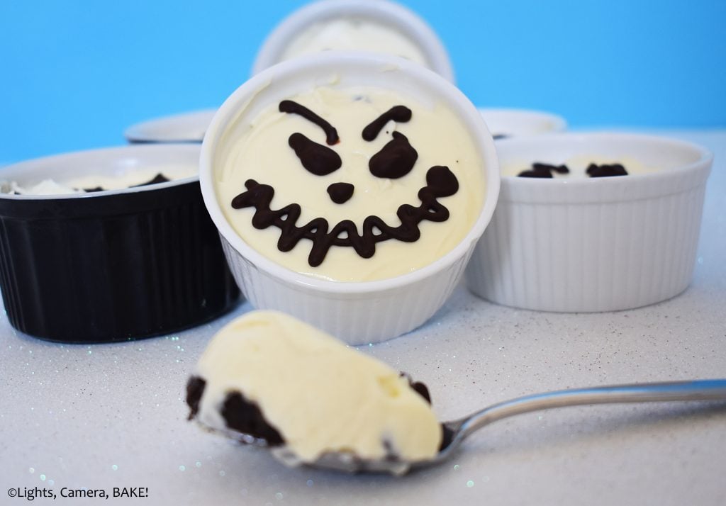 Mini Halloween vanilla cheesecakes in ramekins.